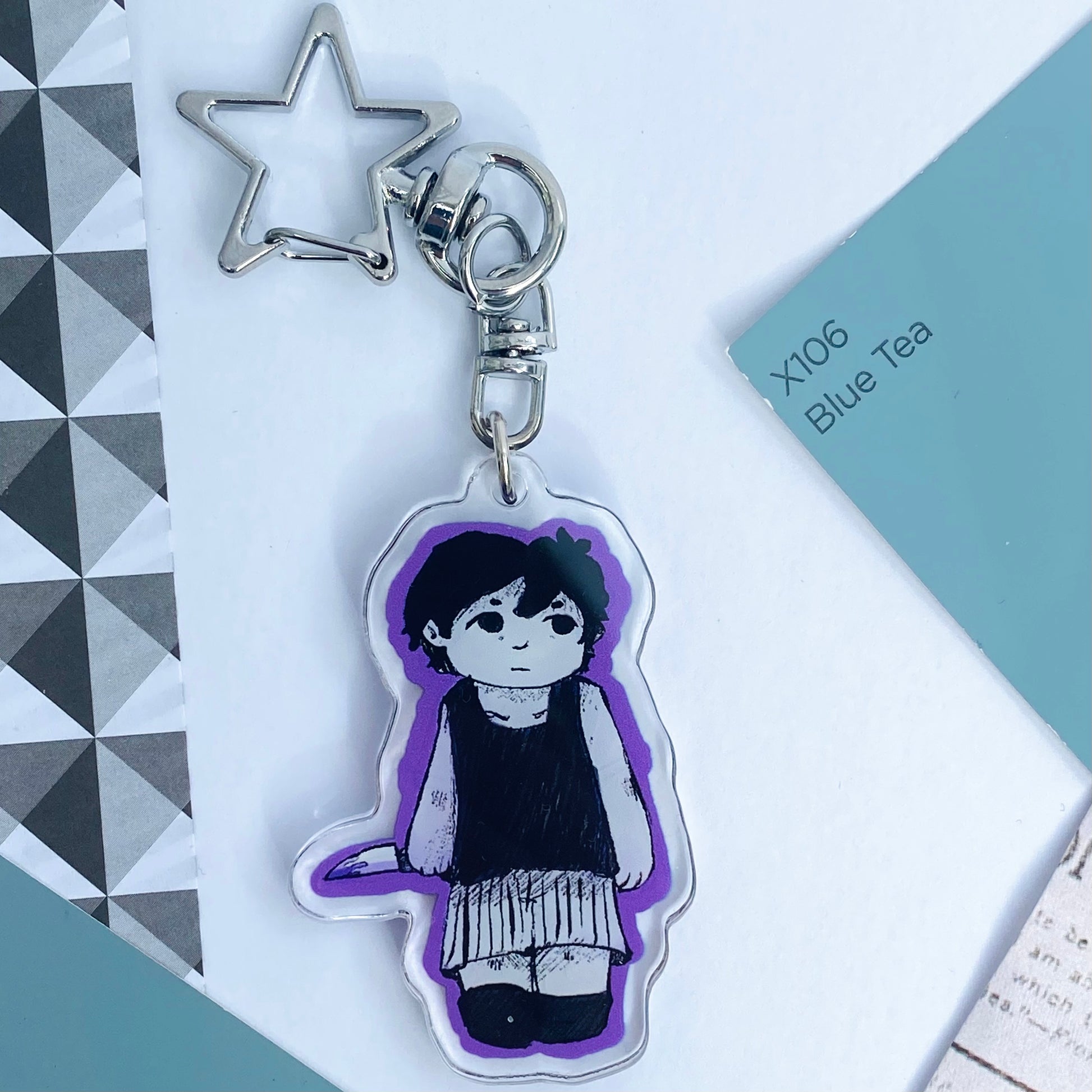 A reversible side of the Sunny keychain showing Omori